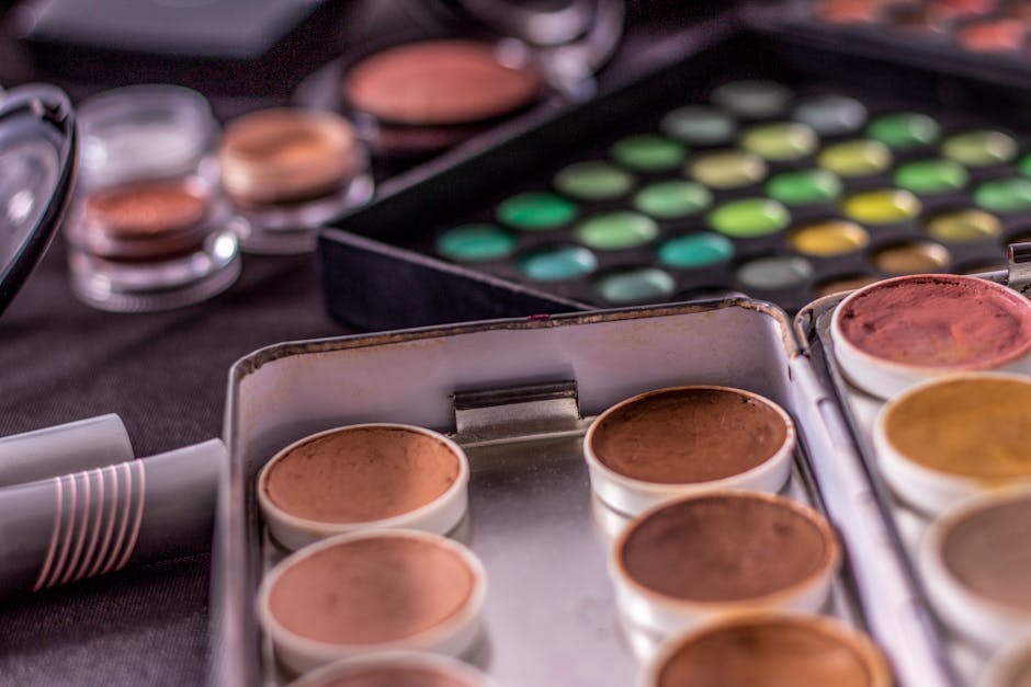 Close-up of colorful makeup palettes showcasing a range of vibrant shades. Ideal for beauty concepts.